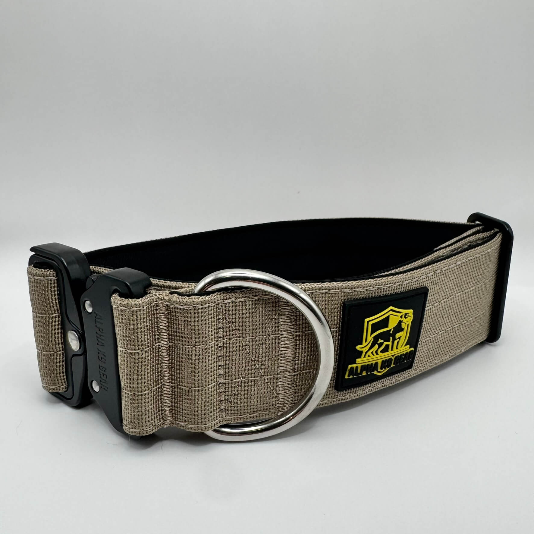 Beige heavy-duty tactical dog collar for large dogs, featuring high-strength nylon, quick-release metal buckle, and signature Alpha K9 Gear branding.