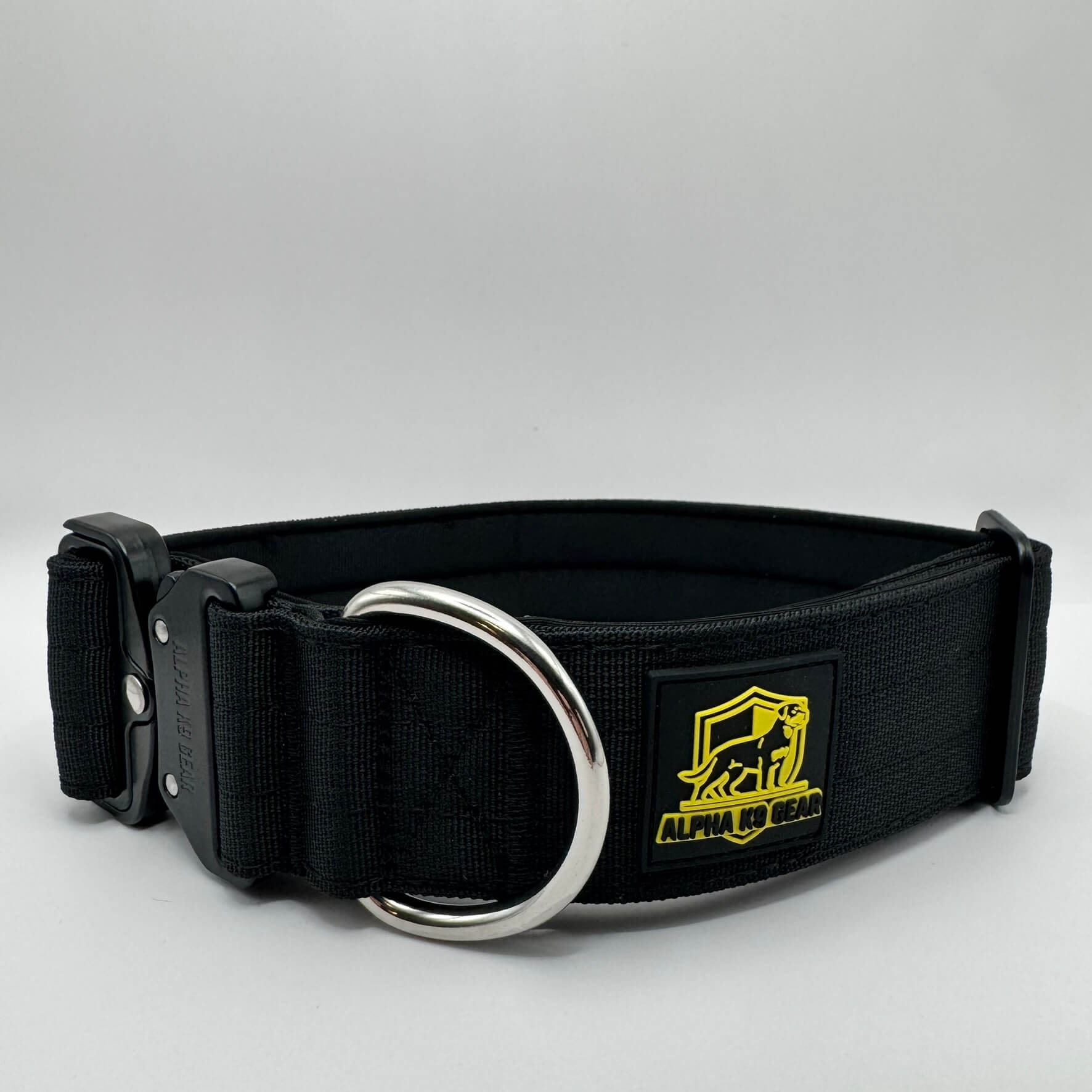 Black heavy-duty tactical dog collar for large dogs, featuring high-strength nylon, quick-release metal buckle, and signature Alpha K9 Gear branding.